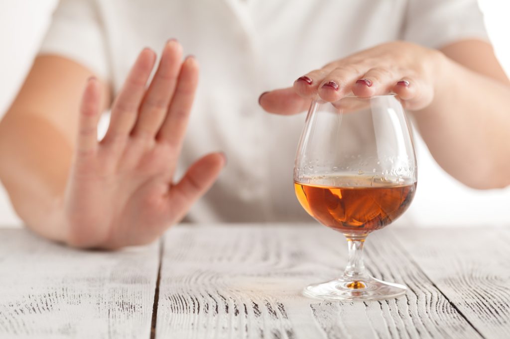 A woman saying no to alcohol drinking