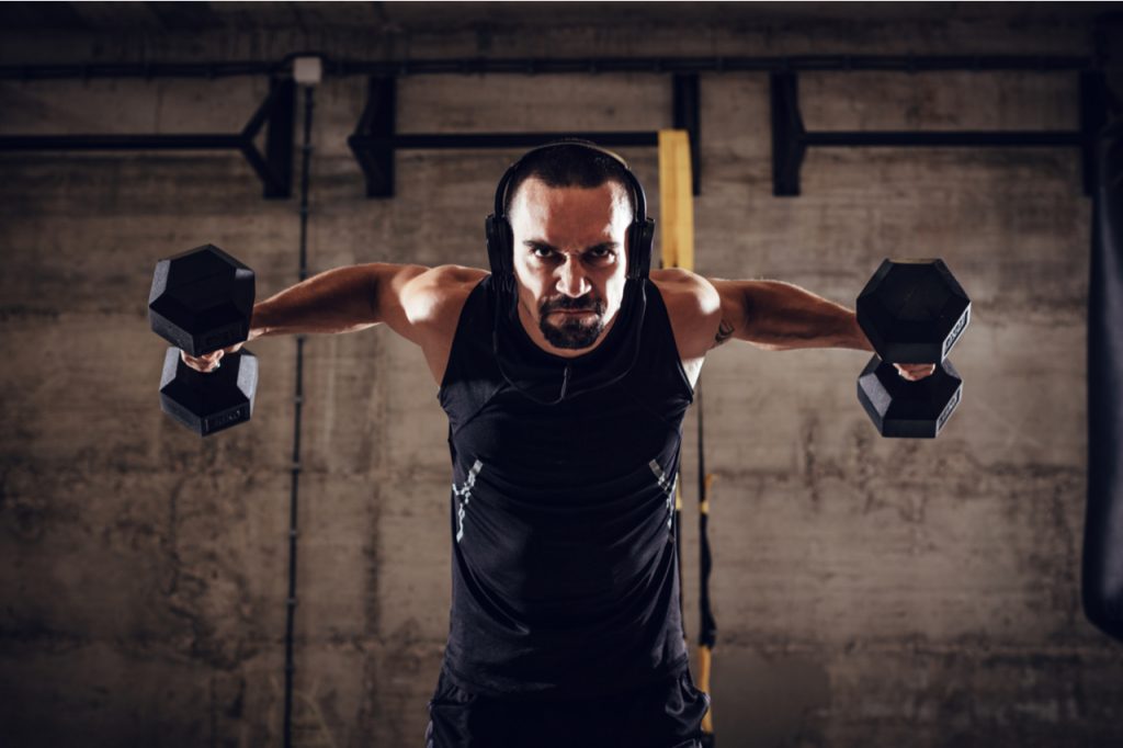 A man doing an arm dumbbell workout.
