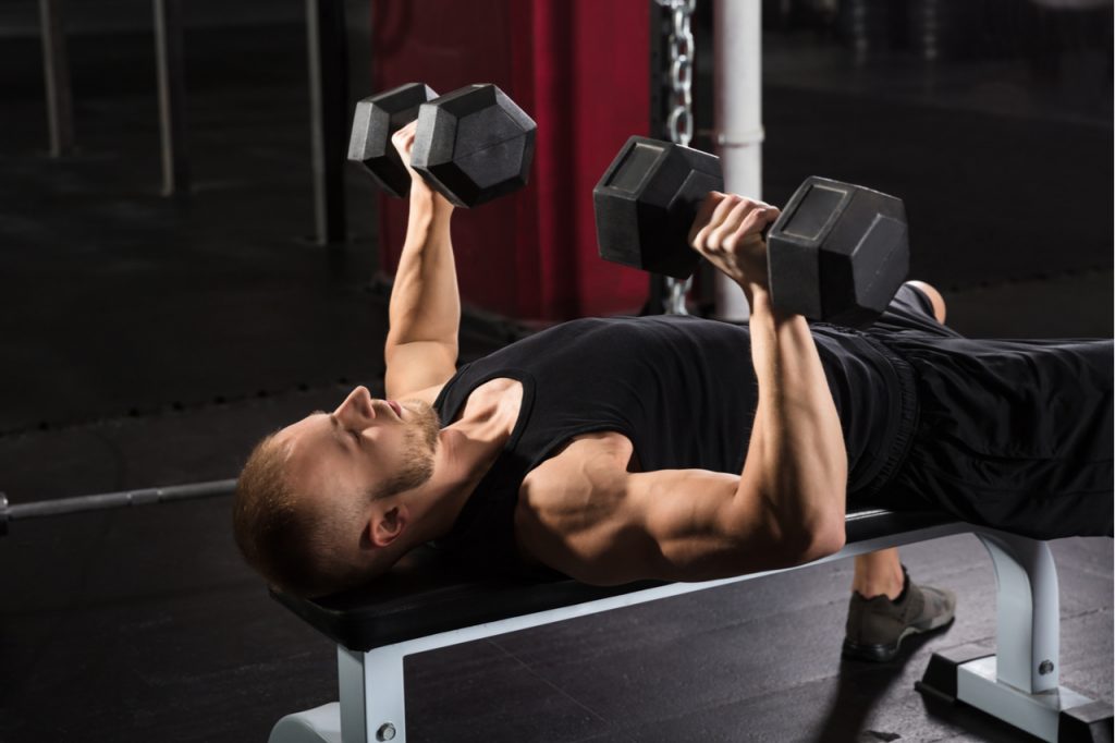 A man doing a dumbbell workout for the back
