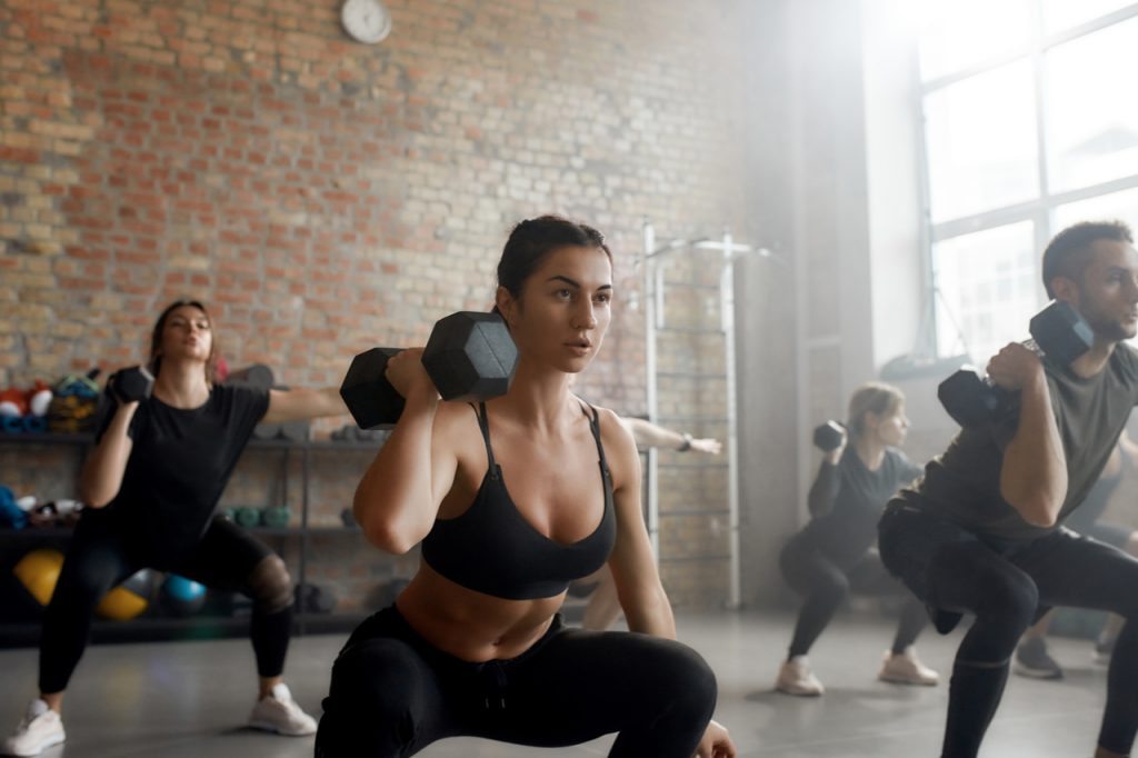 A group doing hiit with dumbbell