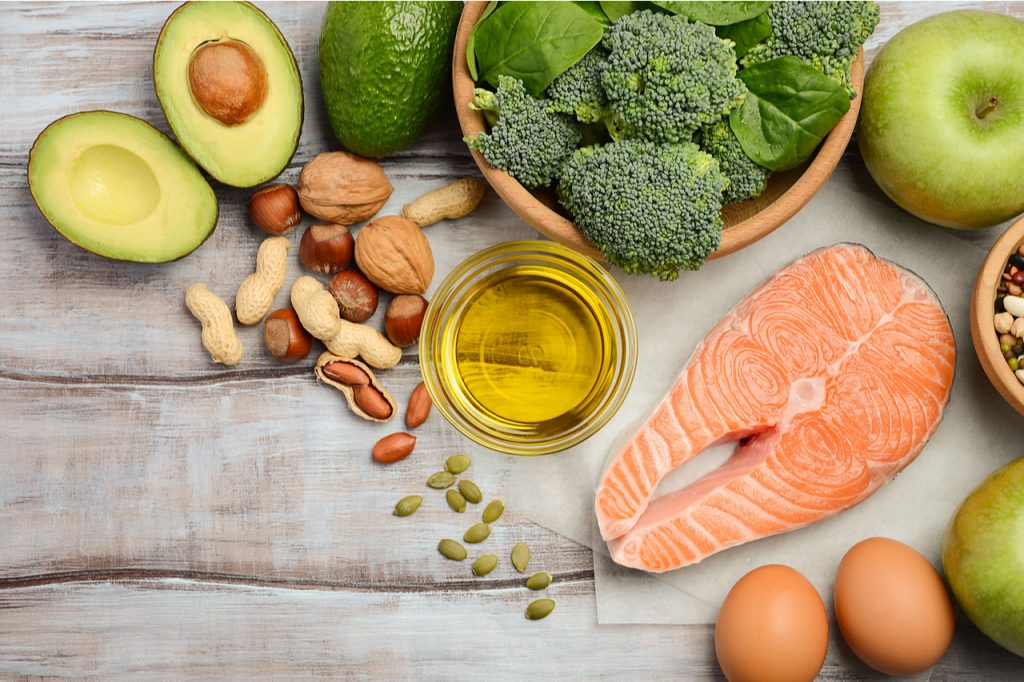 Selection of healthy fatty products from avocado, salmon, nuts, etc.