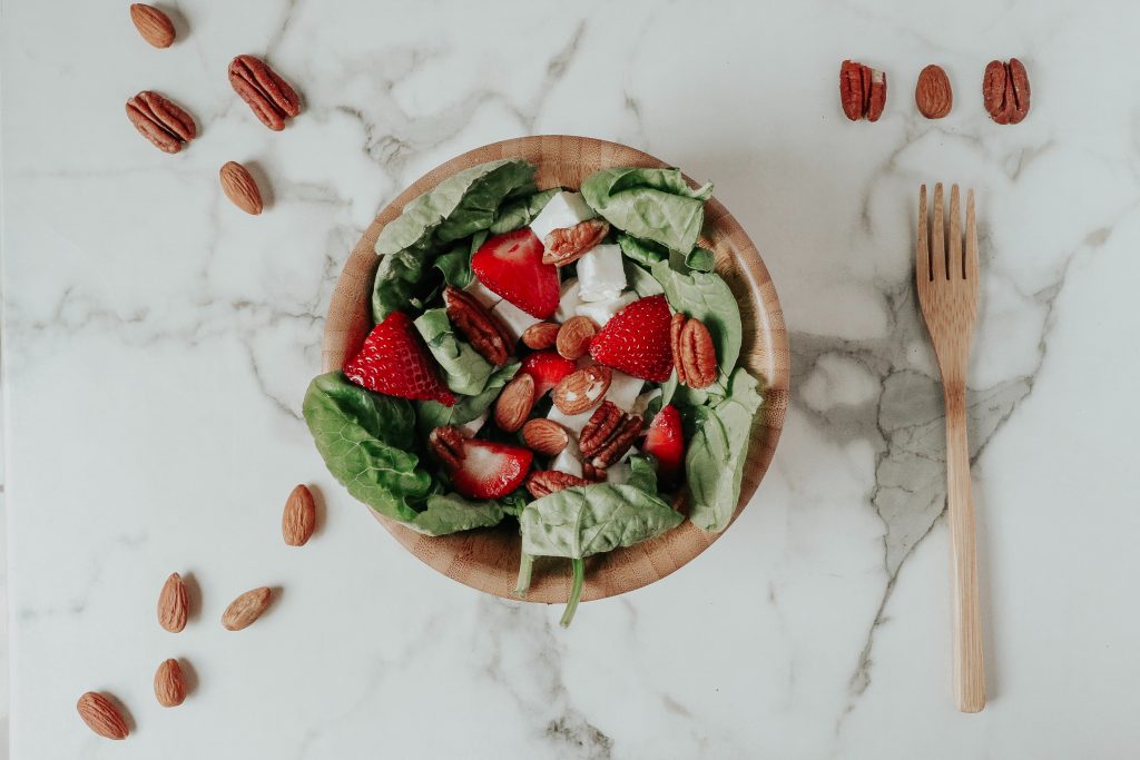 Fruits and vegetable salad in a wooden bowl.