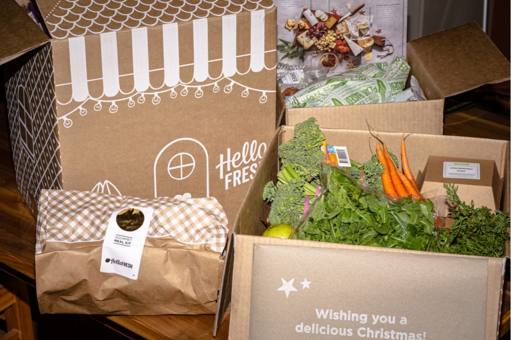 Meal kit delivery services from HelloFresh, includes chicken, ham and sides with cheese platter, desert and fresh vegetables.