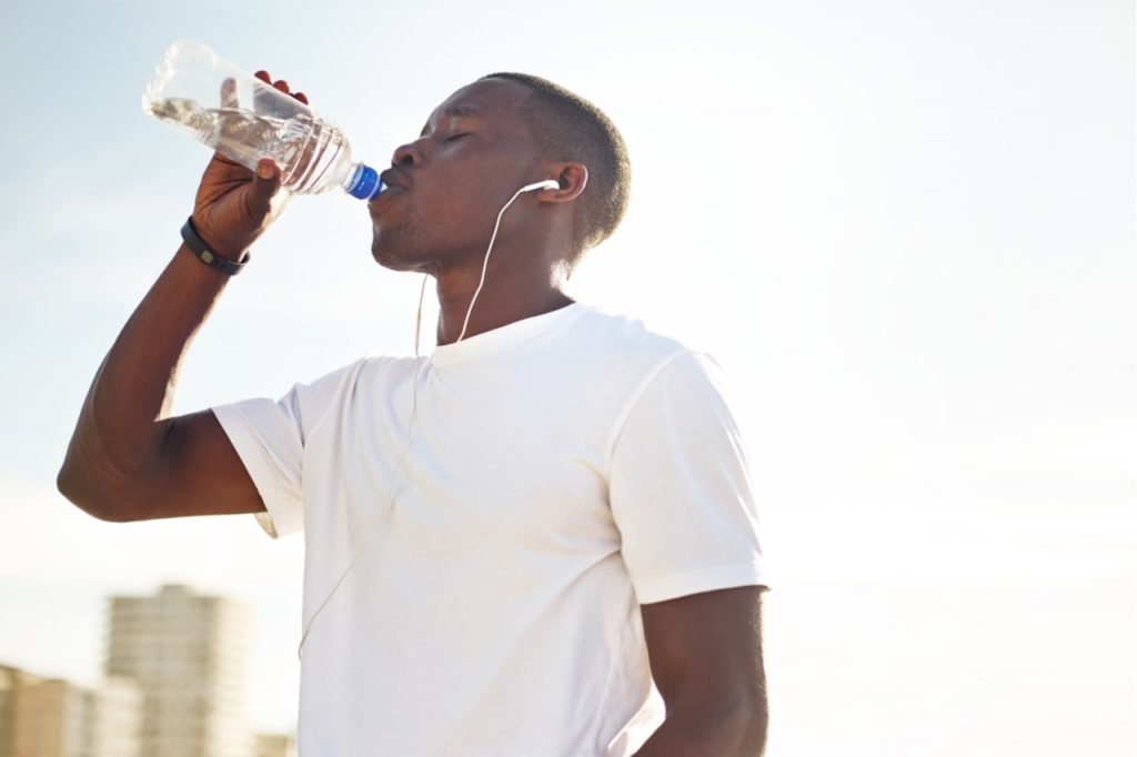 Young man drinking water.