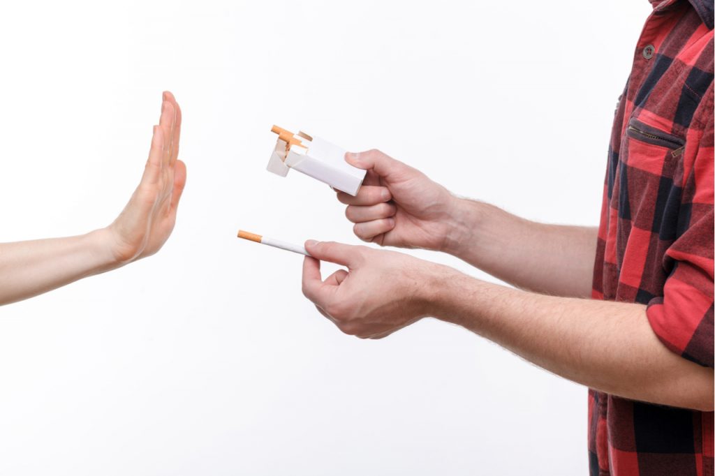 A man offering cigarettes and being declined.