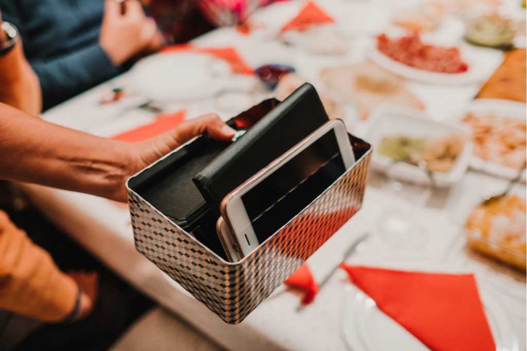 A group of friends having dinner and putting their phone away.