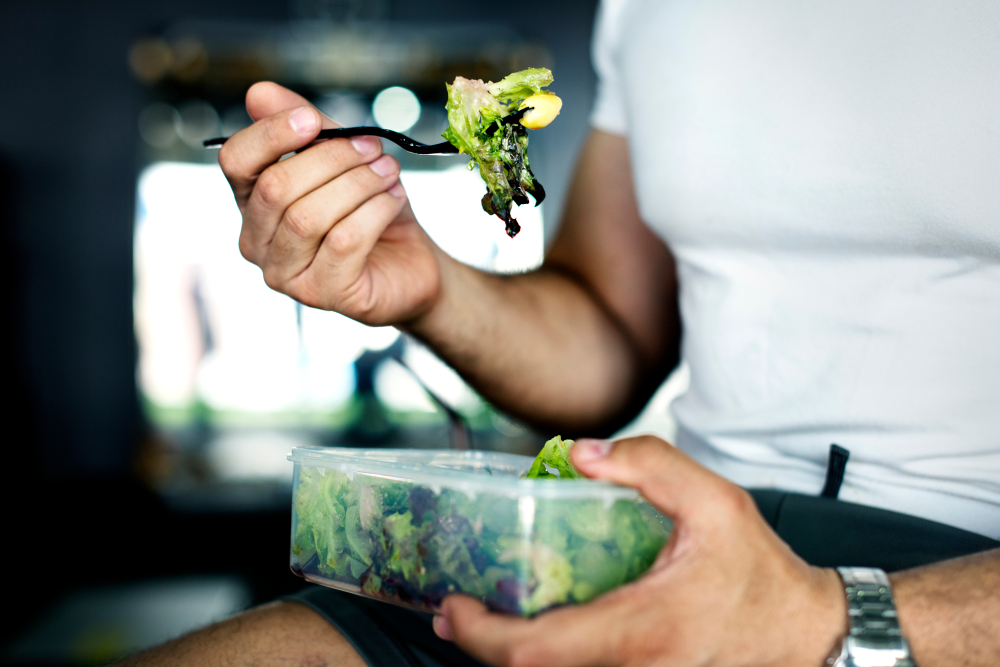 Man eating vegetable salad.