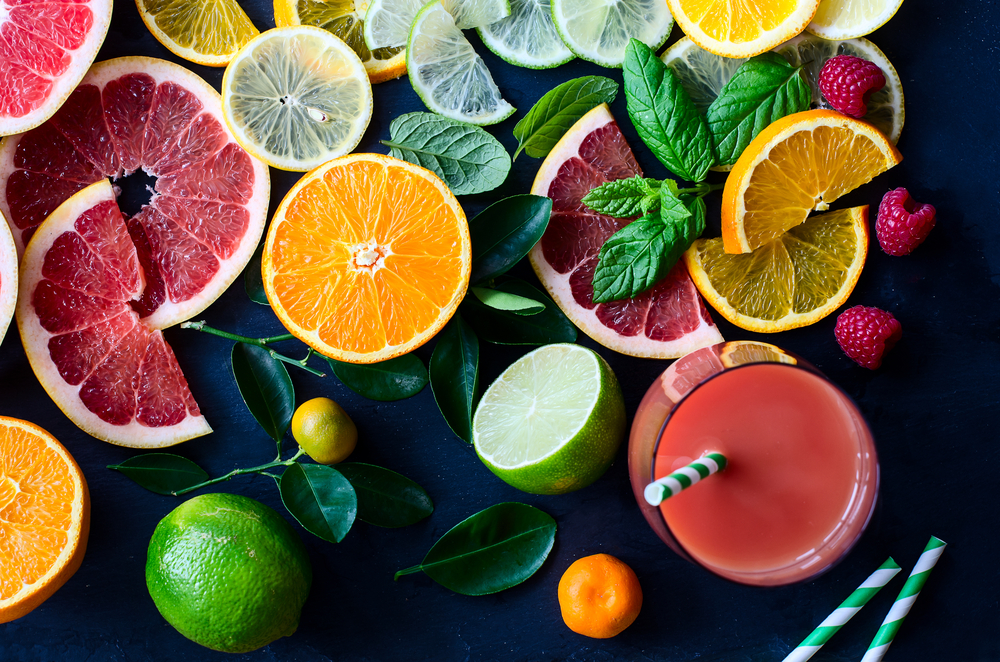 Citrus juice and slices of orange, grapefruit, lemon. Vitamin C