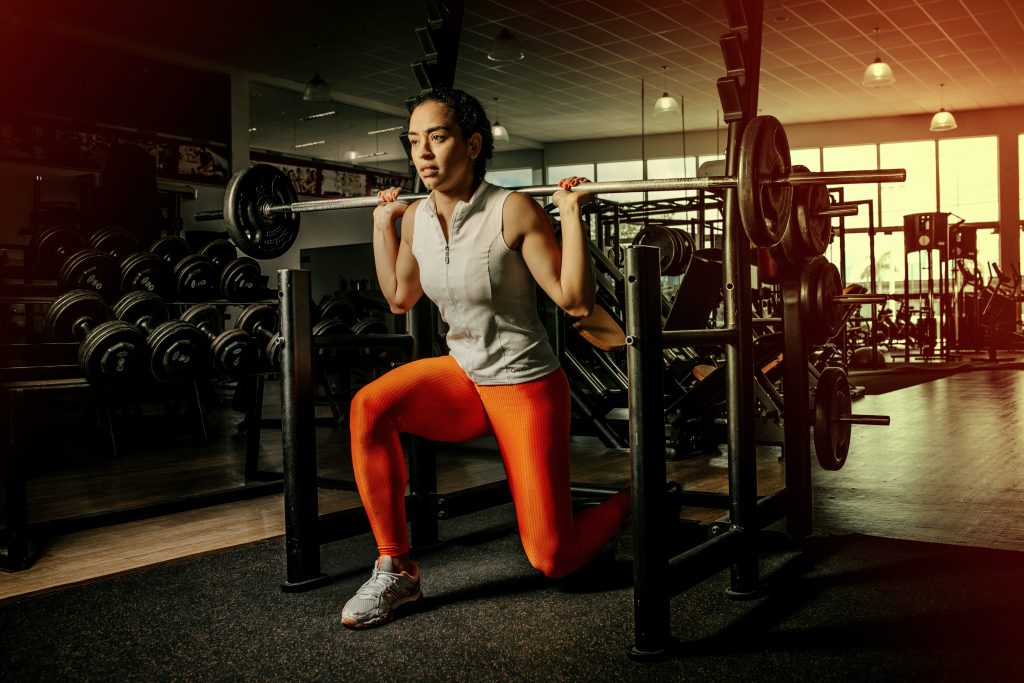 A woman weightlifting for thinner leaner stronger review