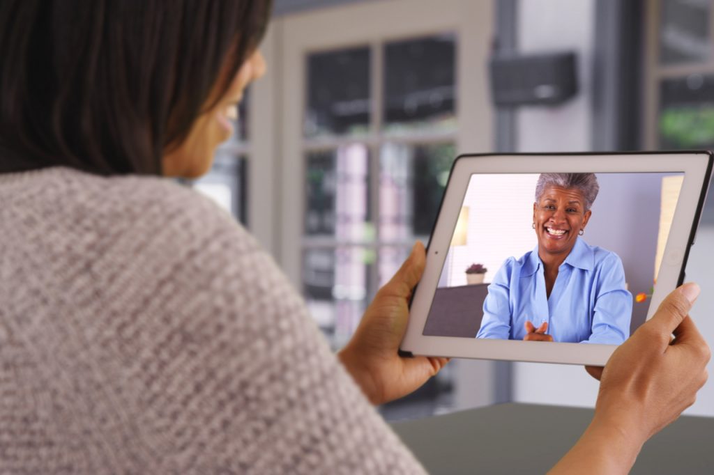 Mother and daughter having a video call using a tablet.