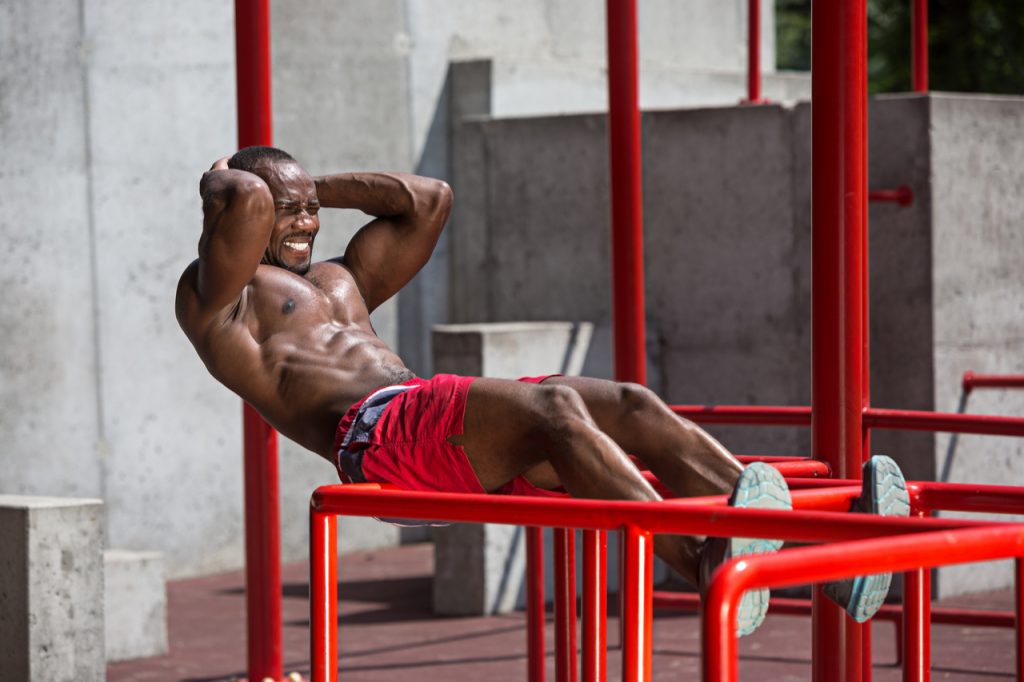 A man doing intense workout in a stadium.