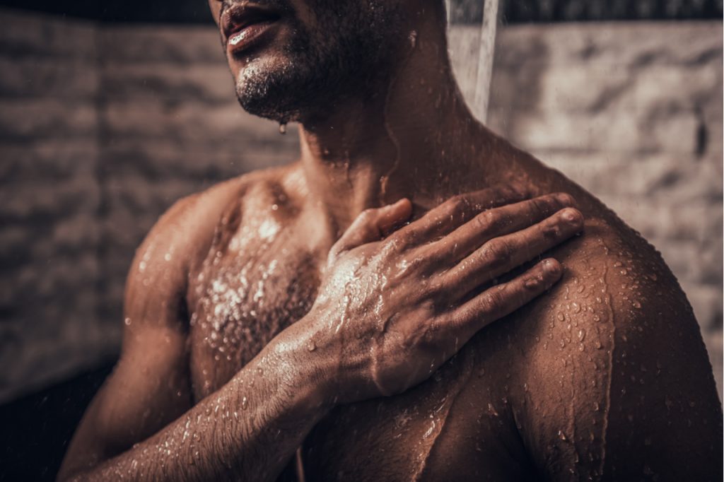 Man taking cold shower in bathroom at morning.