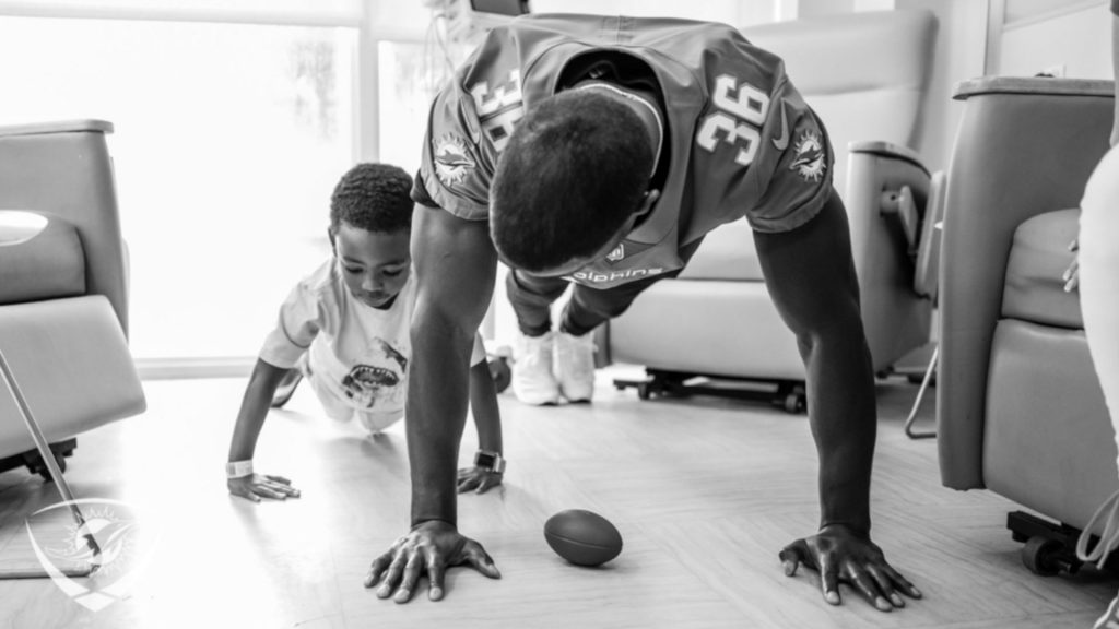 Doug Middleton and a toddler doing push-ups