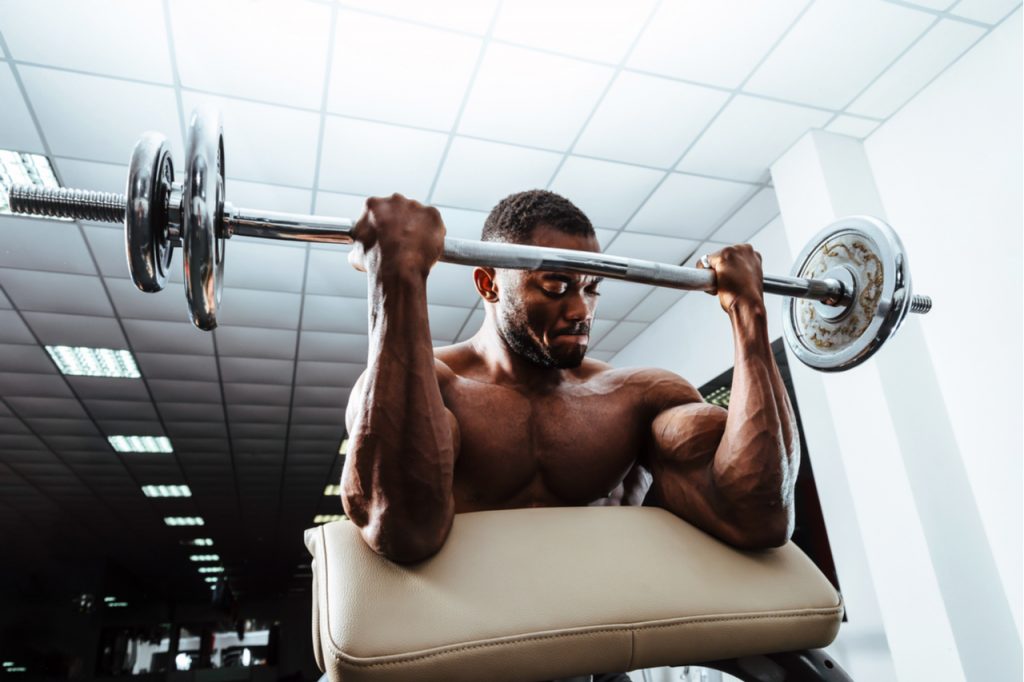 A man doing some weightlifting for the arms.