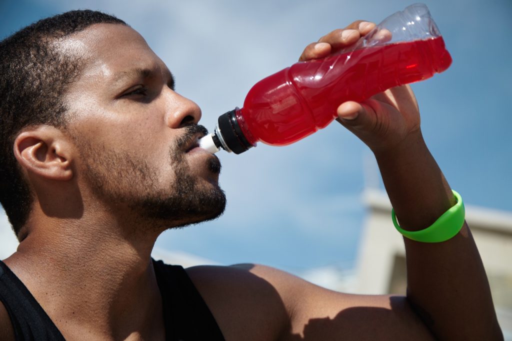 A man drinking to rehydrate.