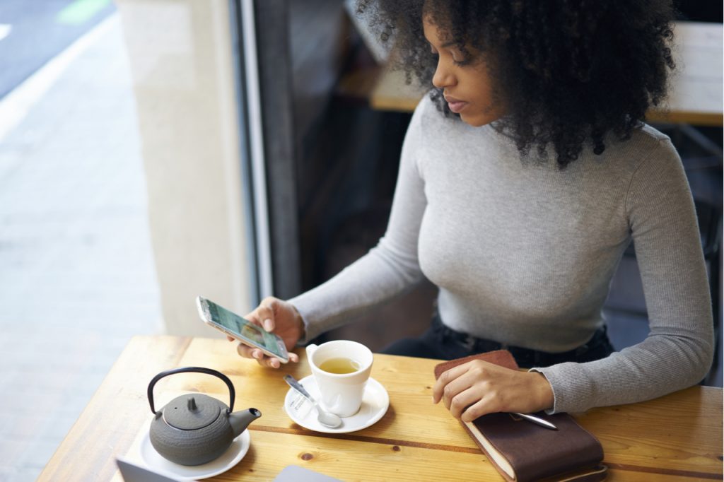 Woman checking her monthly subscriptions online via her mobile phone.