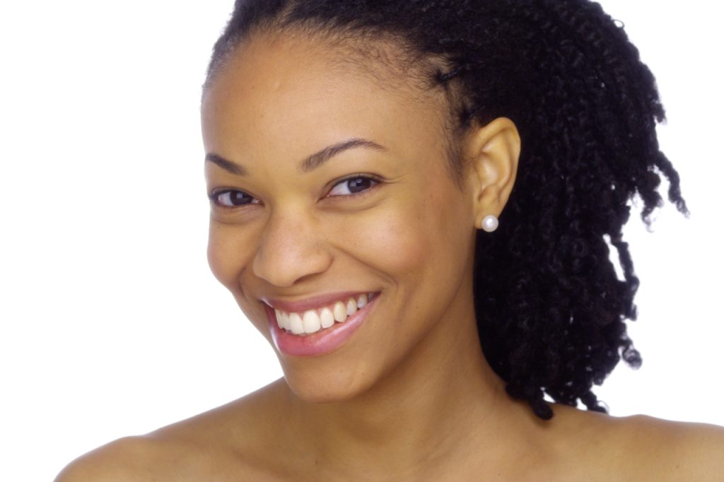 Woman smiling with pearly white healthy teeth.