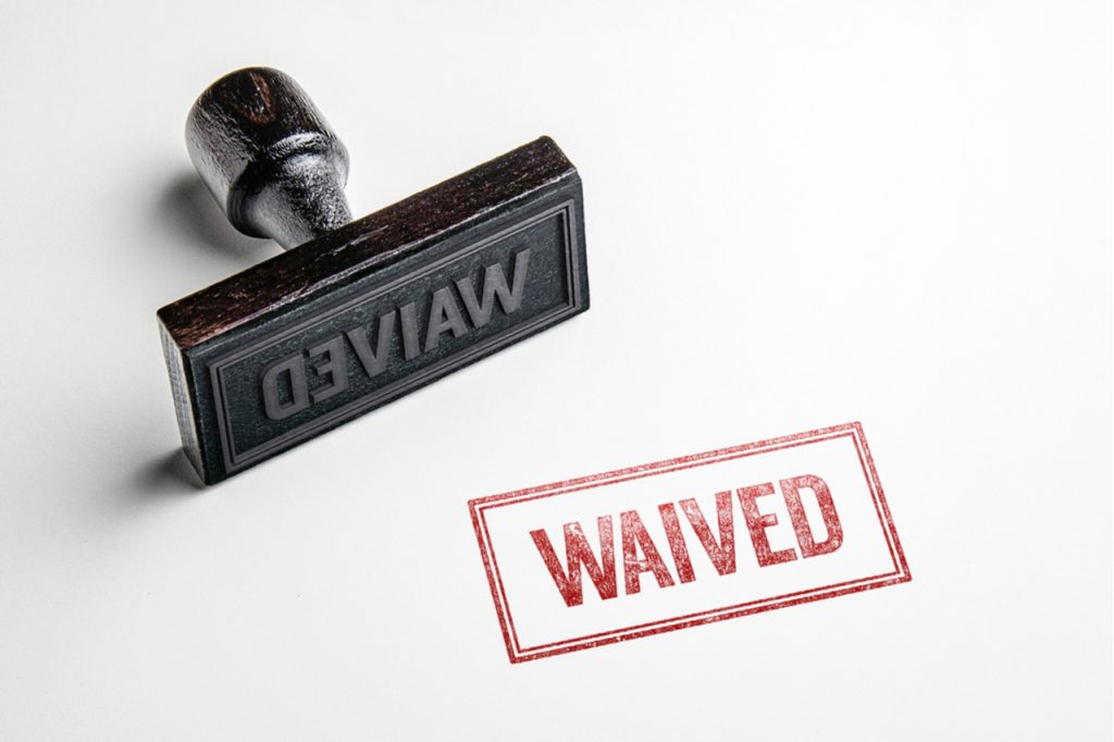 Rubber stamping that says waived in red ink.