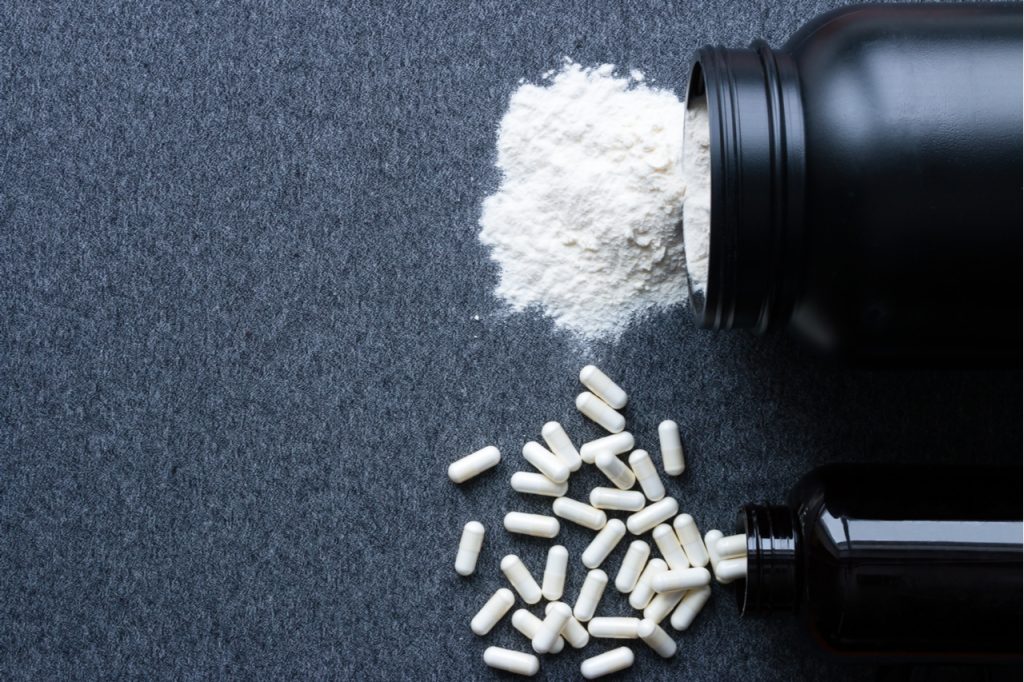 Jars with nutritional supplements like kre alkalyn for bodybuilding.