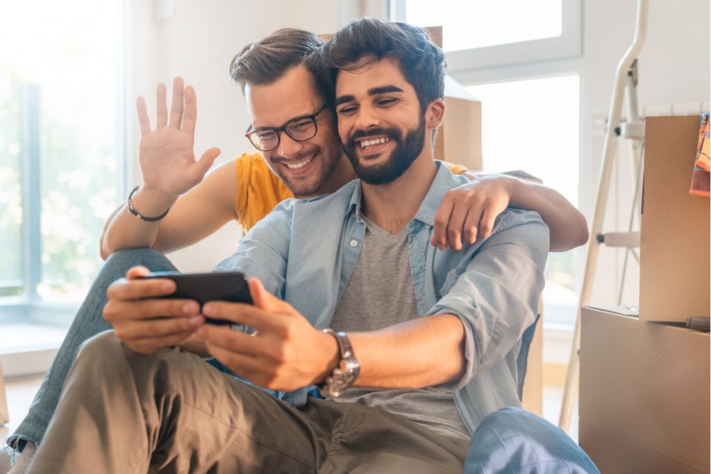 Happy gay couple on a video call.