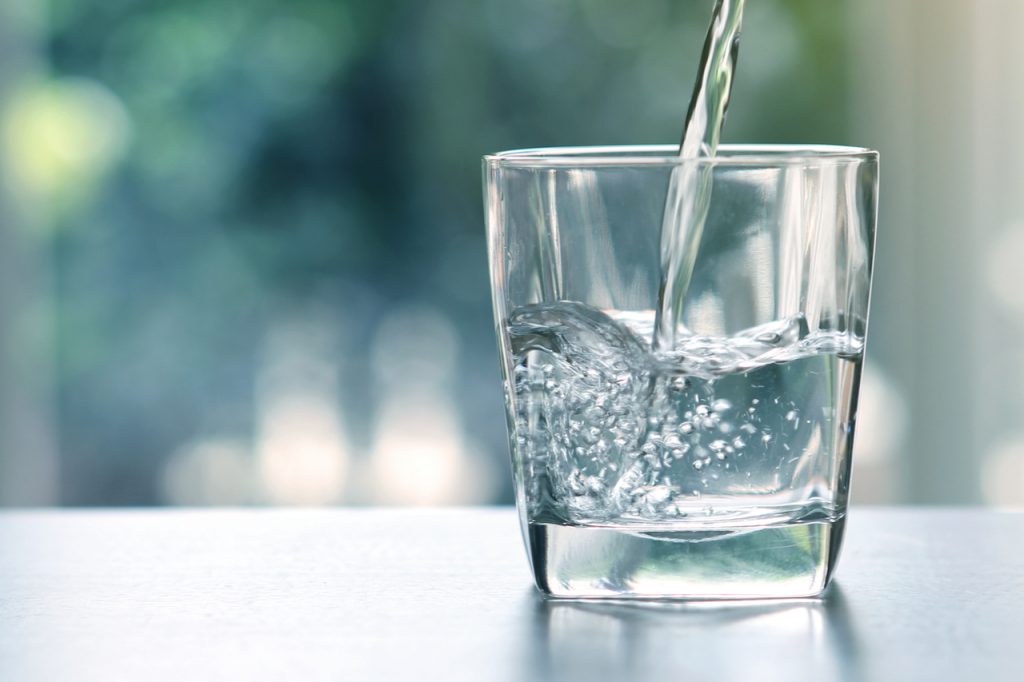 Pouring water in a glass.