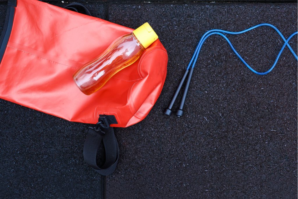 View of skipping rope on the gym bag isolated on rubber tarmac.