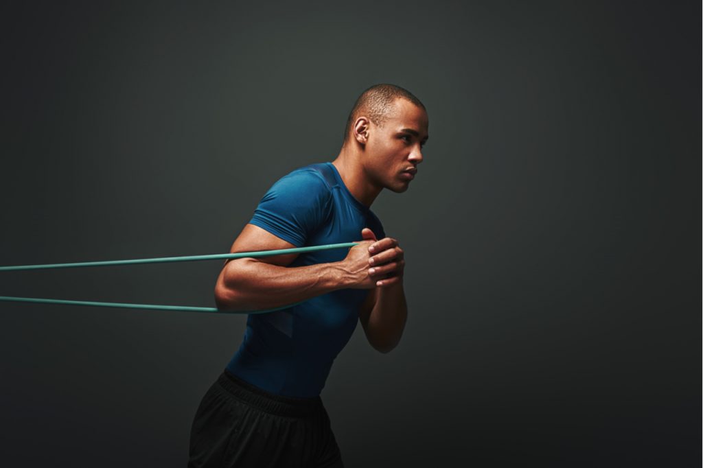A man working out using a resistance band.