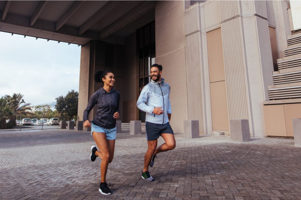 A couple doing a morning jog a way for them to stop drinking coffee in the morning.