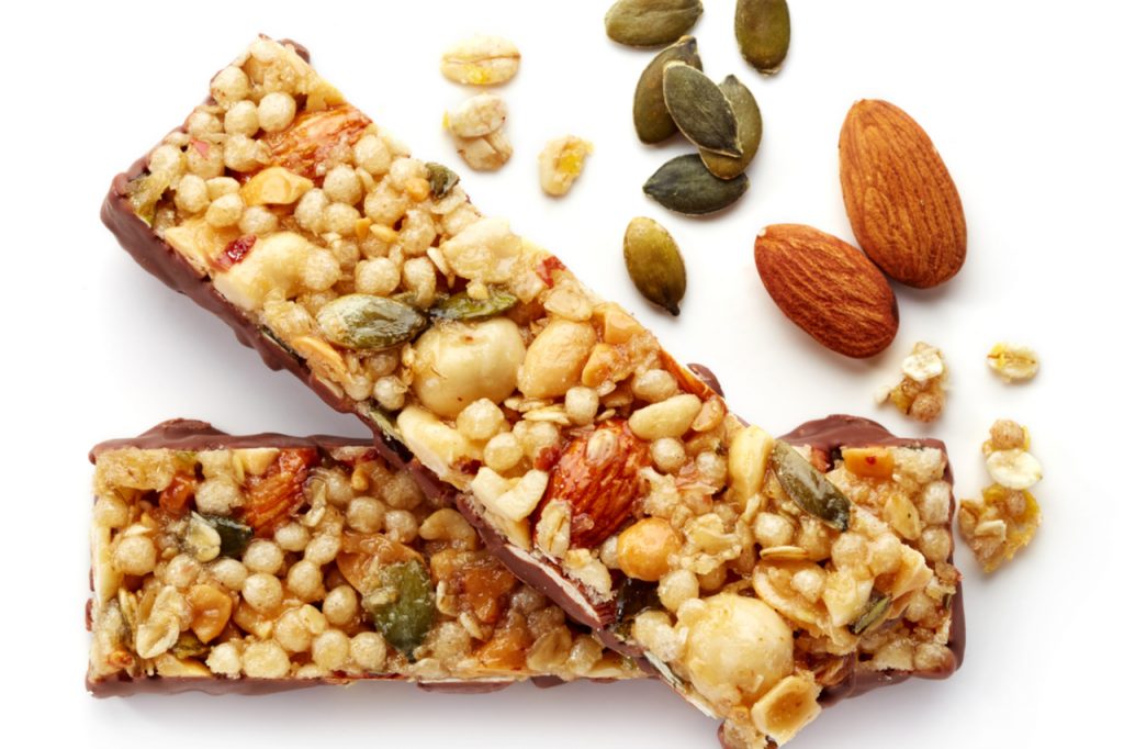Protein bars, almond and sunflower seeds on the side.