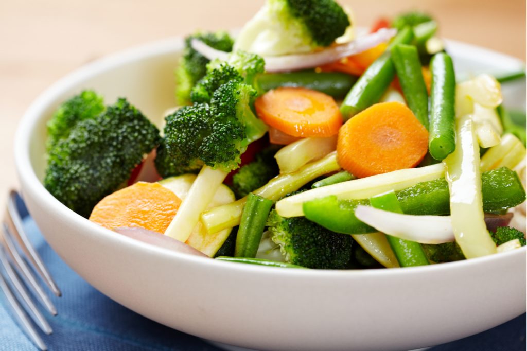 Stir-fried vegetables in a bowl. Add more vegetables in the your diet to avoid chronic diseases.