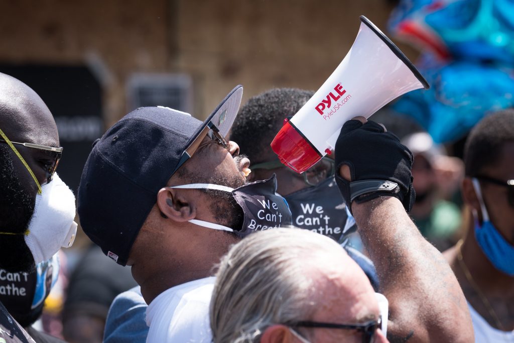 Terrence Floyd, George Floyd's brother with a megaphone during his speech talking about violence.