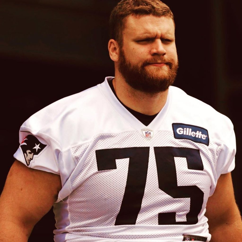 NFL Player Ted Karras wearing his white number 75 Jersey.