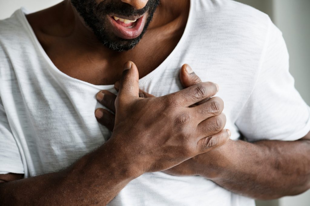 An African American man having chest pains.