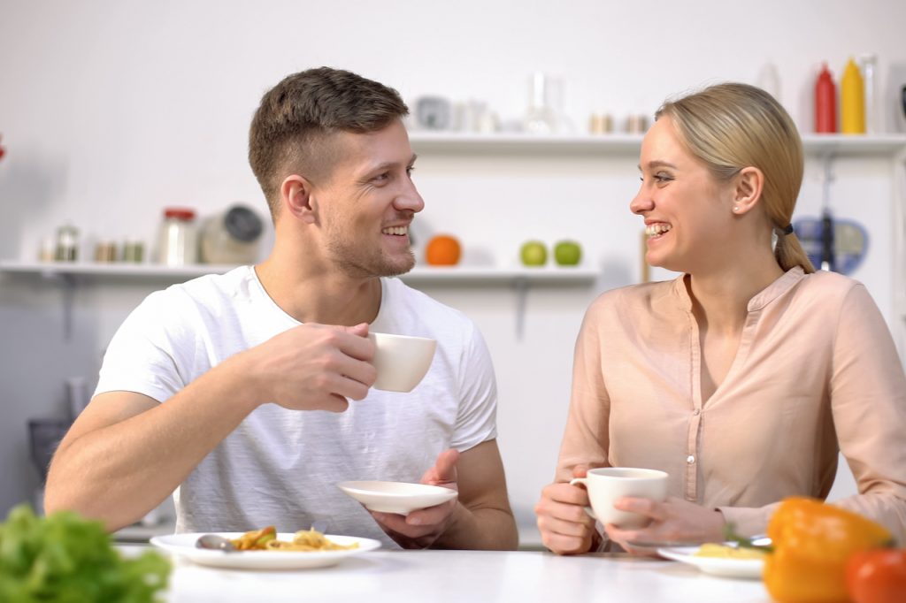 A couple drinking tea after eating their meal.