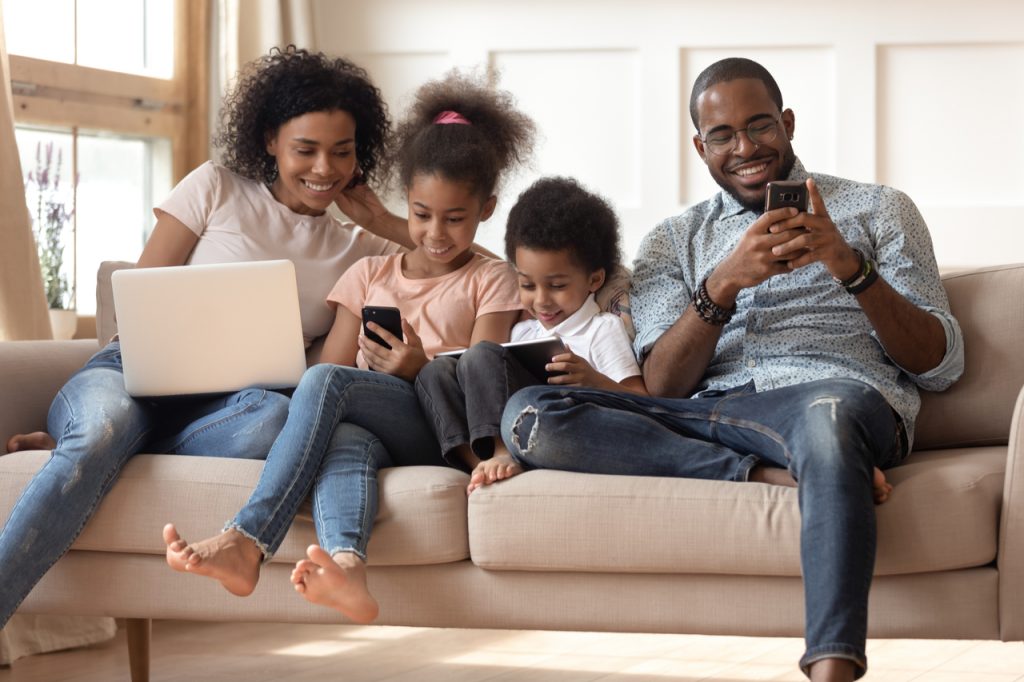 An african american family happily bonding at home. Kids spending time with their parents to celebrate parent's day.