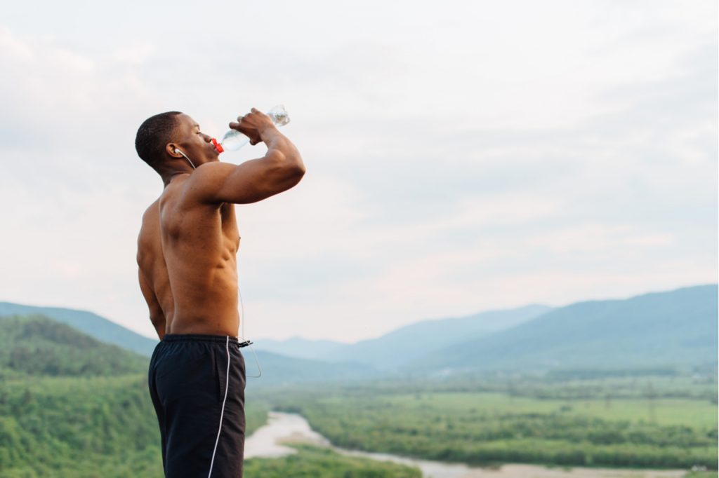 Man drinking water after sports training.