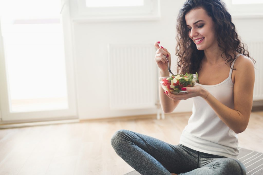 Woman eating mindfully after fitness workout