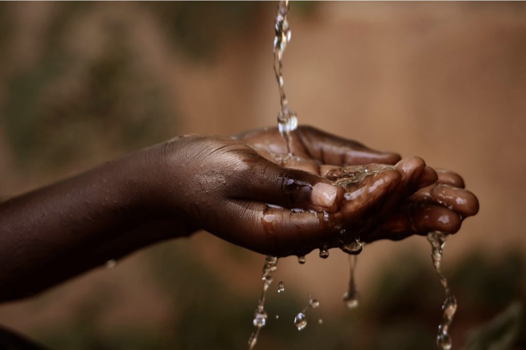 Water pouring in a child's hands.