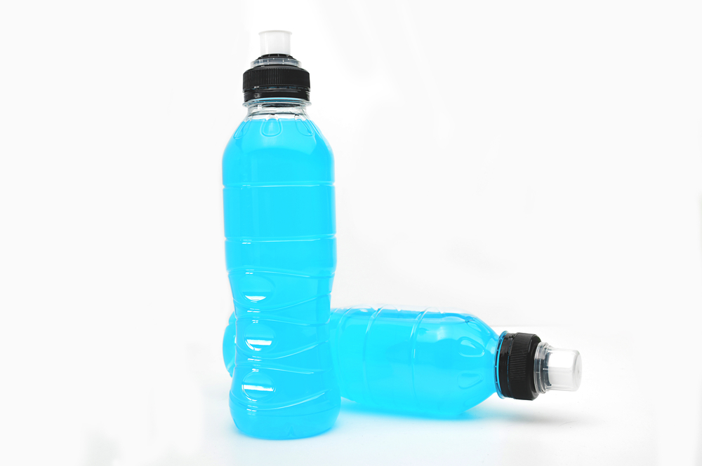 sports drink on wooden table and white background