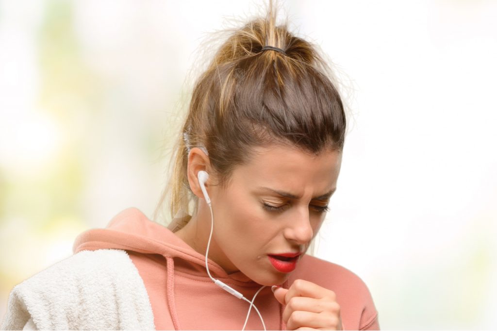 Young sport woman wearing workout sweatshirt sick and coughing with weak immune system.