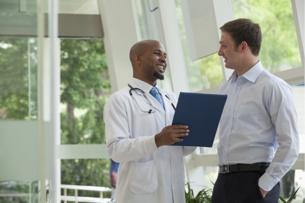 A man talking to his doctor about his health.