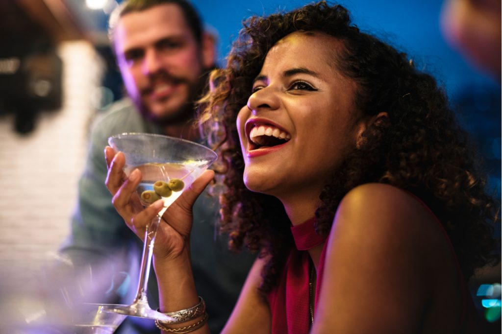 Woman having fun while drinking cocktail.