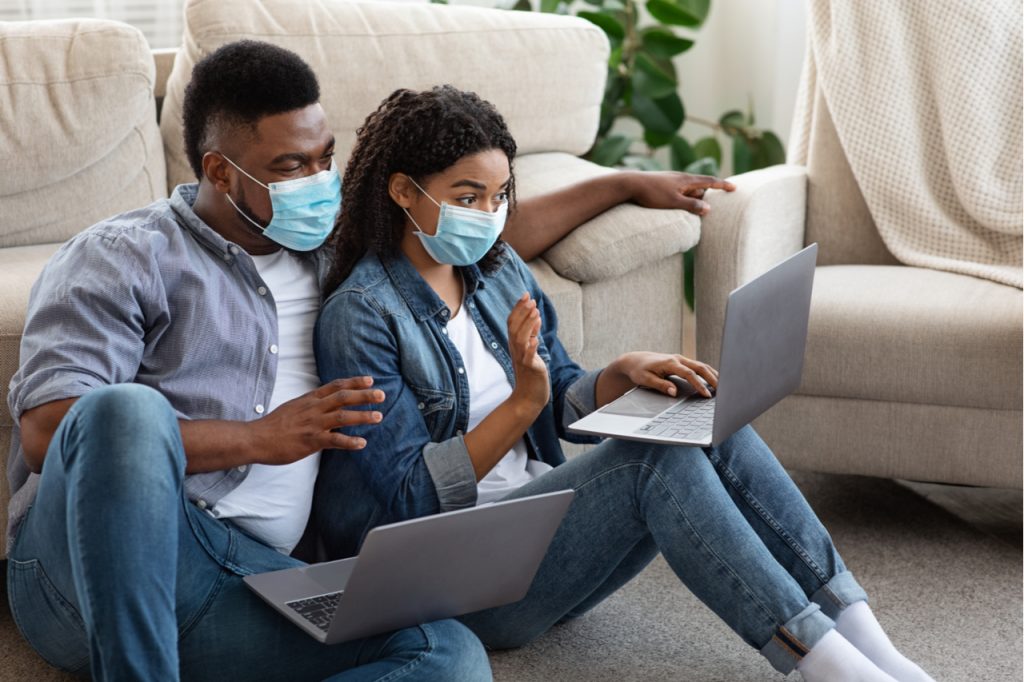 A young couple doing a video call with their friends, staying connected.