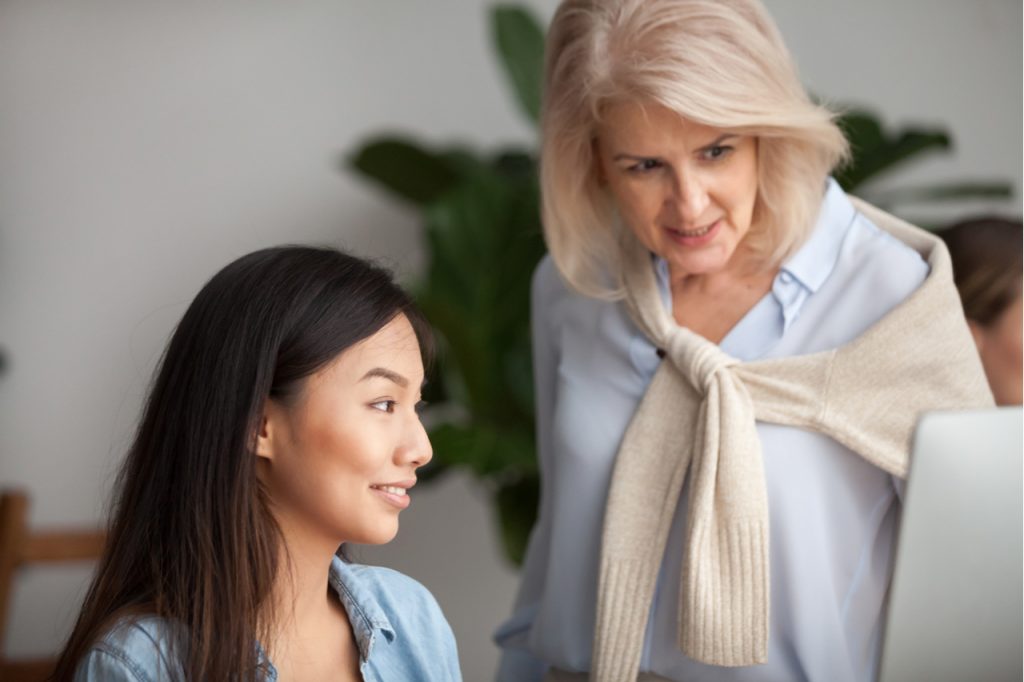 Female leader mentoring a young female associate.