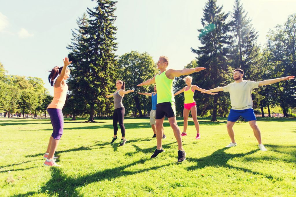Group of people doing fitness outdoor classes.