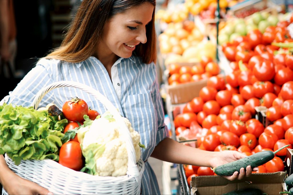 Woman shopping vegetables and fruits.