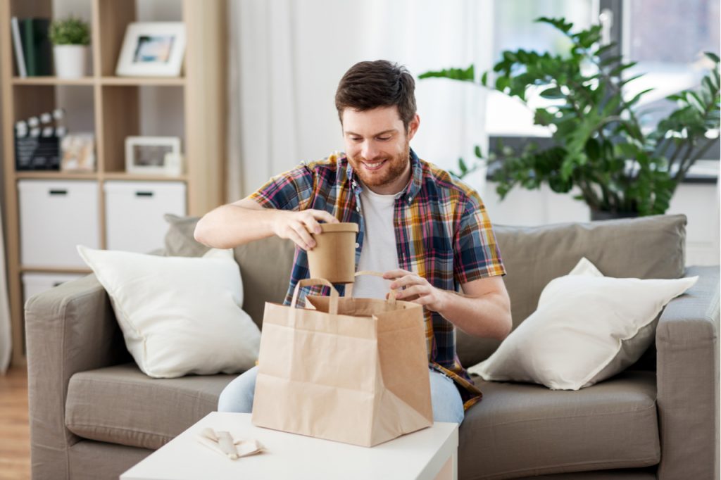 A man unpacking his delivered food.
