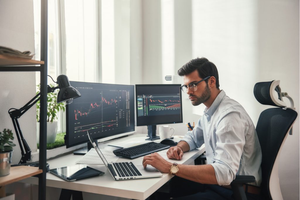 Busy man looking in his computer, understanding the stock market.