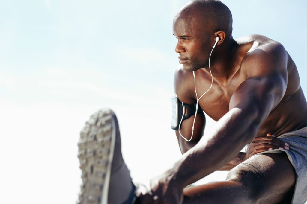 Young man working out against sky.