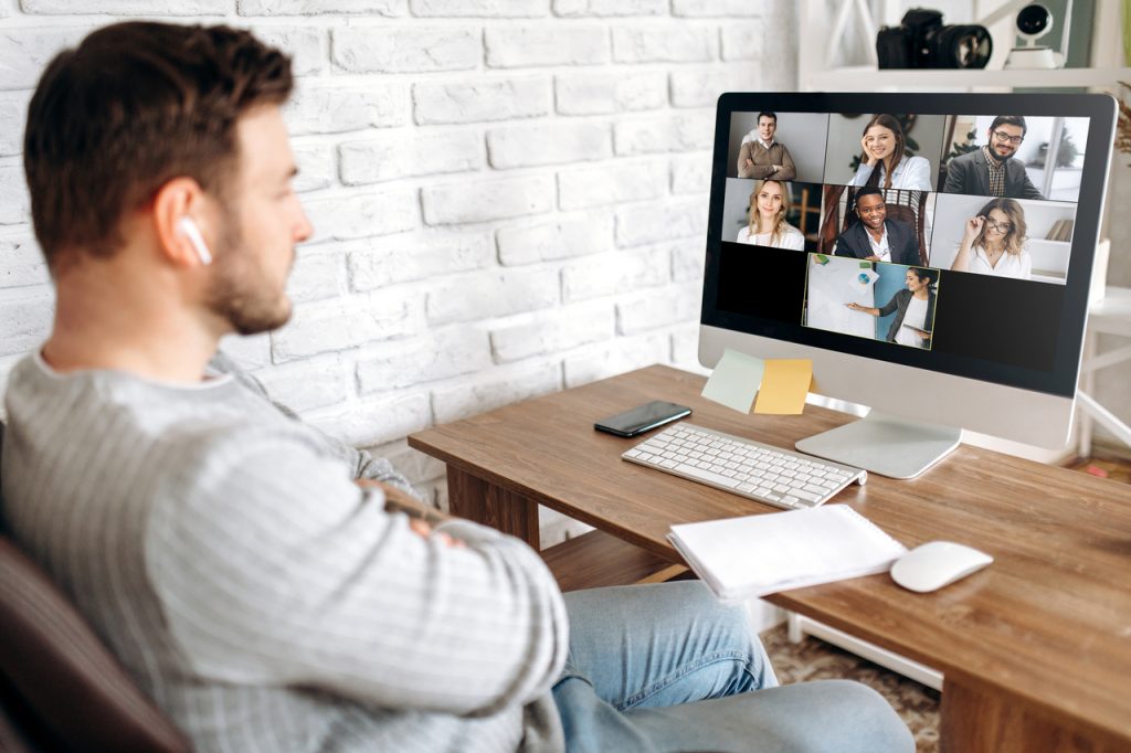 Man doing videoconferencing with a mental health support group.
